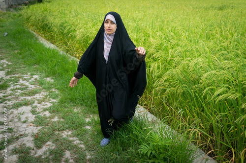 Foto Beautiful happy Muslim woman in green field