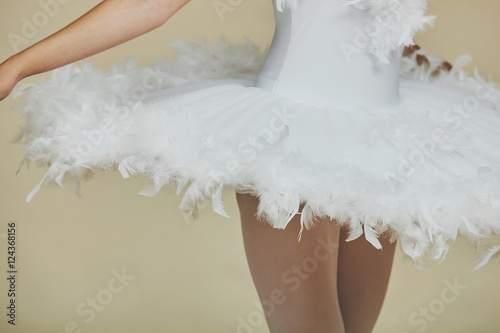 Closeup of ballerina in white dress.