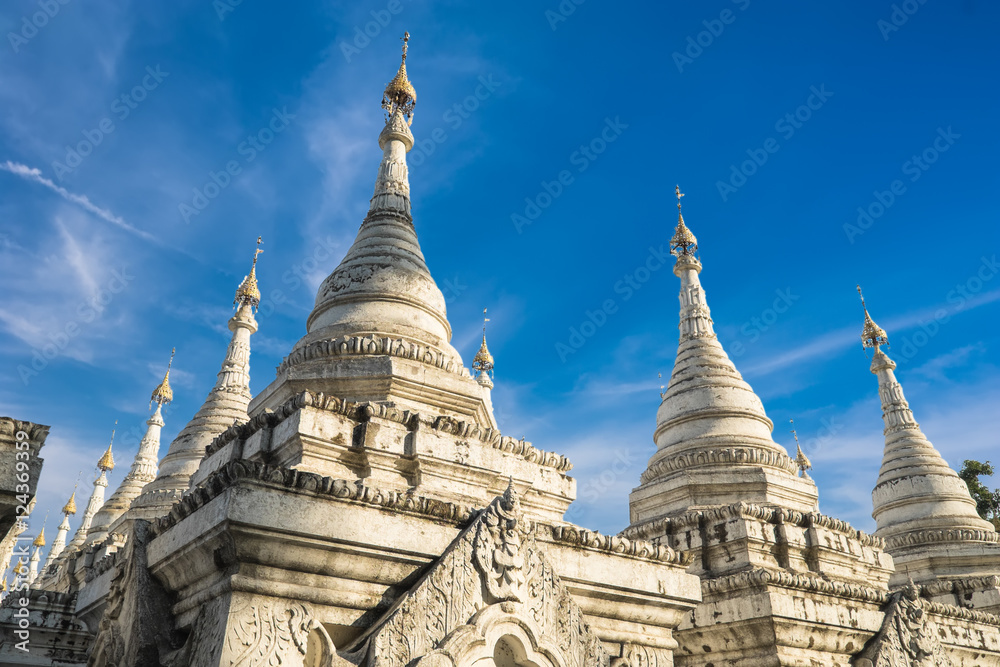 Sandamuni Pagoda with row of white pagodas. Amazing architecture of Buddhist Temples at Mandalay. Myanmar (Burma) travel landscapes and destinations