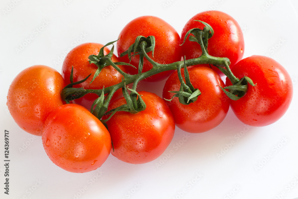 Branch red tomato cherry on a white background