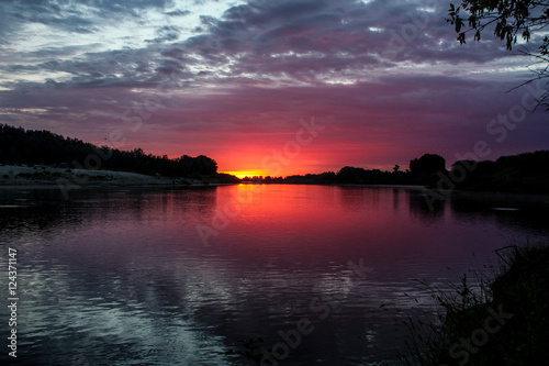 Fototapeta Naklejka Na Ścianę i Meble -  A wonderful view of the sunset on the river in Russia