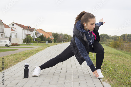 Young woman exercise prior to running photo