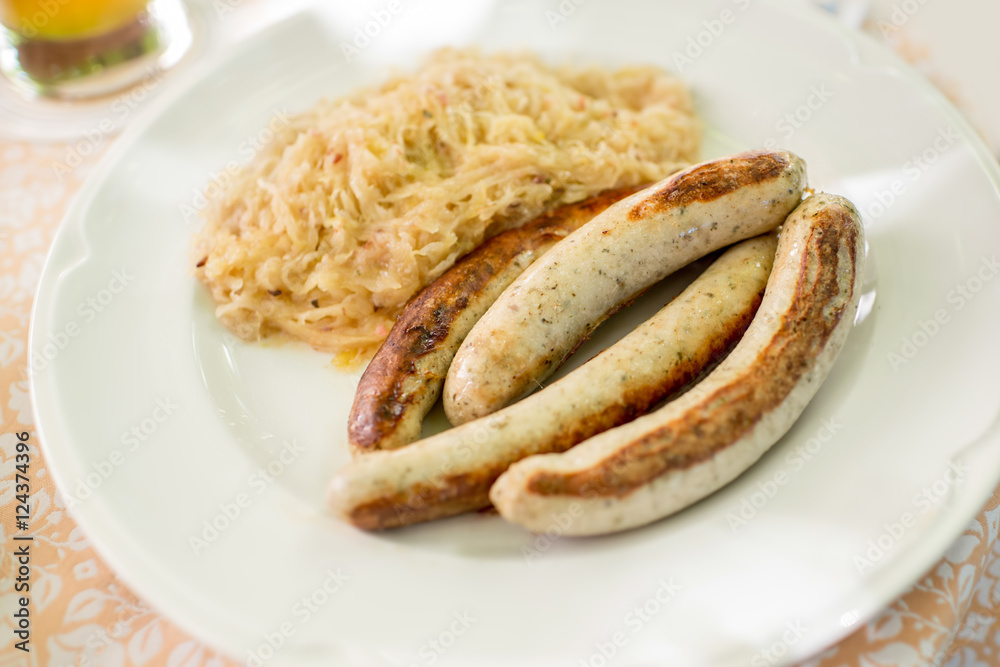 Bavarian traditional meal with sausages and cabbage on the plate Bavarian traditional meal with sausages and cabbage on the plate