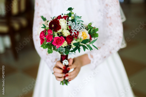 Bouquet of roses in the hands bride