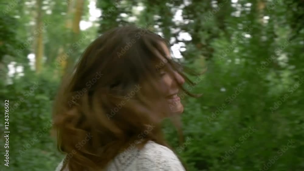 Beautiful girl young attractive woman in nature outdoors spinning smile happy and looking at camera relaxed fun emotion healthy girl smiling hipster look slowmotion slow motion