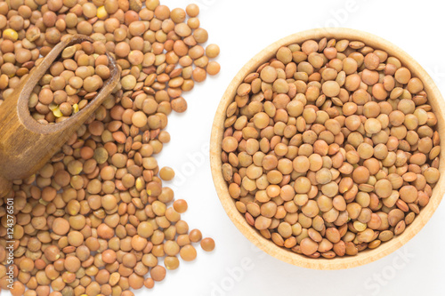 Brown lentils. Wooden scoop