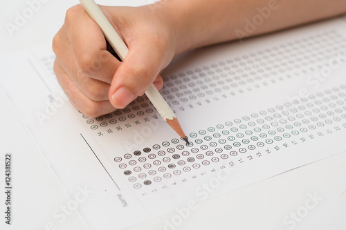 woman's hands filling in standardized test form
