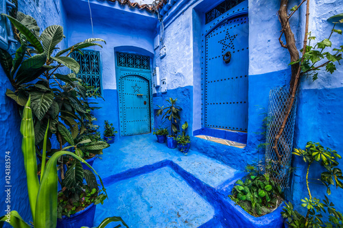 Traditional blue door on an old street inside Medina of Chefchaouen, Morocco