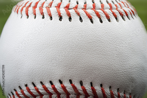 Macro image of a baseball with the closeup on the stitches with copy space