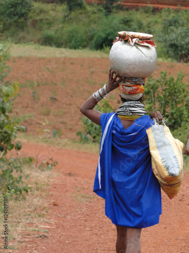 Bonda tribal woman carries moonshine