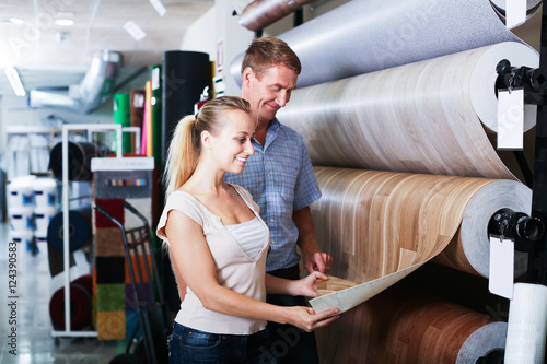 Couple choosing linoleum in store
