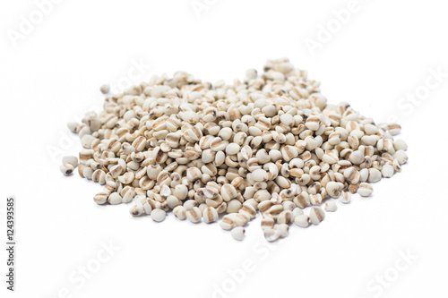 Raw millet rice in wooden spoon on white background.
