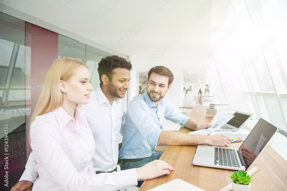 Cheerful young workers are planning new project Cheerful young workers are planning new project