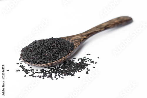 black sesame on wooden spoon isolated on white