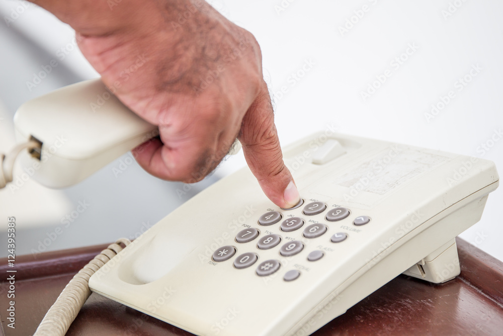 Man is pressing a number on telephone close up. Man is pressing a number on telephone close up.