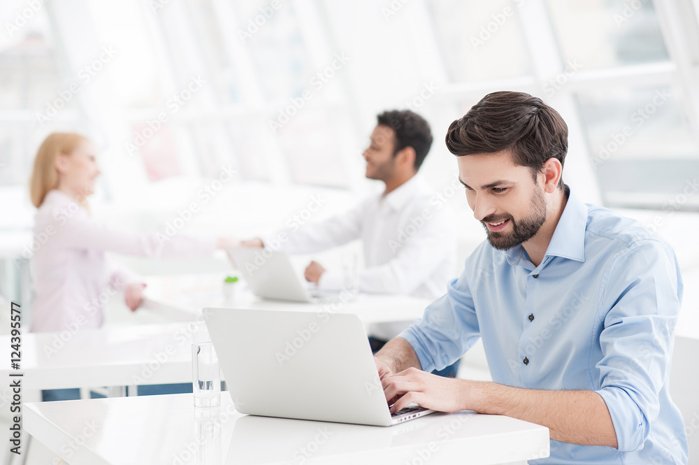 Handsome businessman working in his office