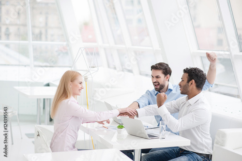 Young coworkers having brainstorming session in modern office