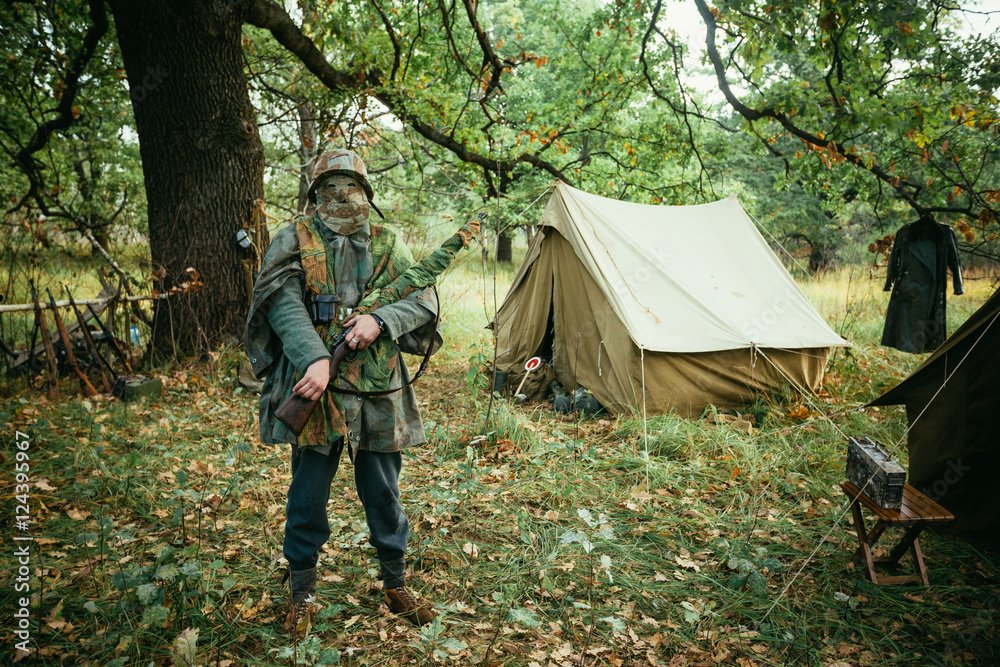 Naklejka premium Hidden unidentified re-enactor dressed as World War II german we
