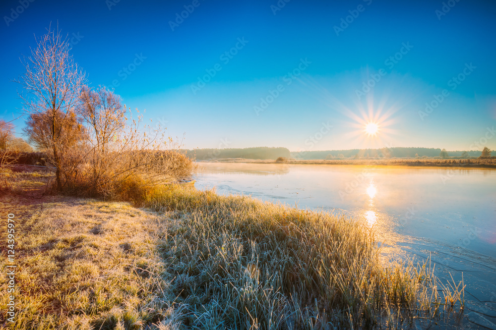 Sun Rises Over River. Autumn Frost Frozen River Covered With Thin Ice.