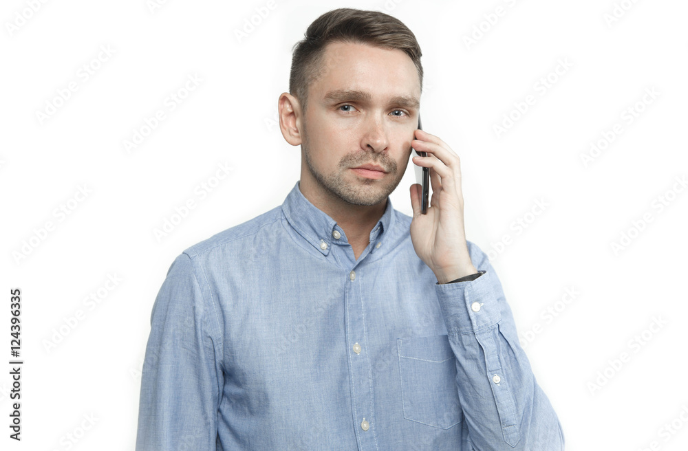 Serious young man talking on mobile isolated on white background Serious young man talking on mobile isolated on white background
