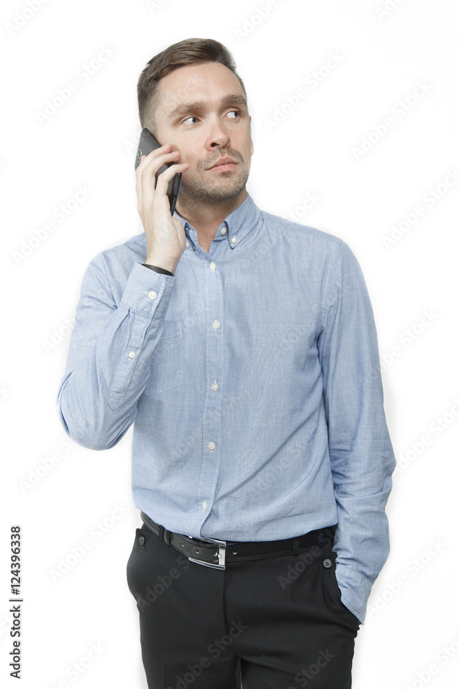 Serious young man talking on mobile isolated on white background Serious young man talking on mobile isolated on white background