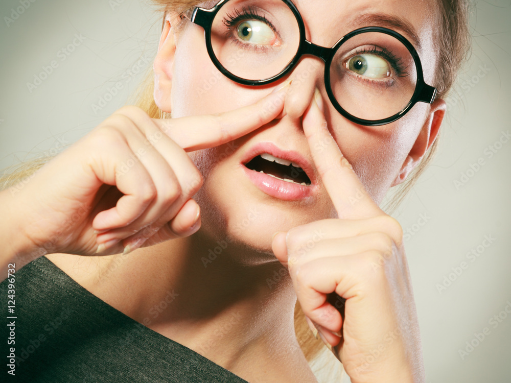 Girl pinches her nose because of stench stink. Girl pinches her nose because of stench stink.