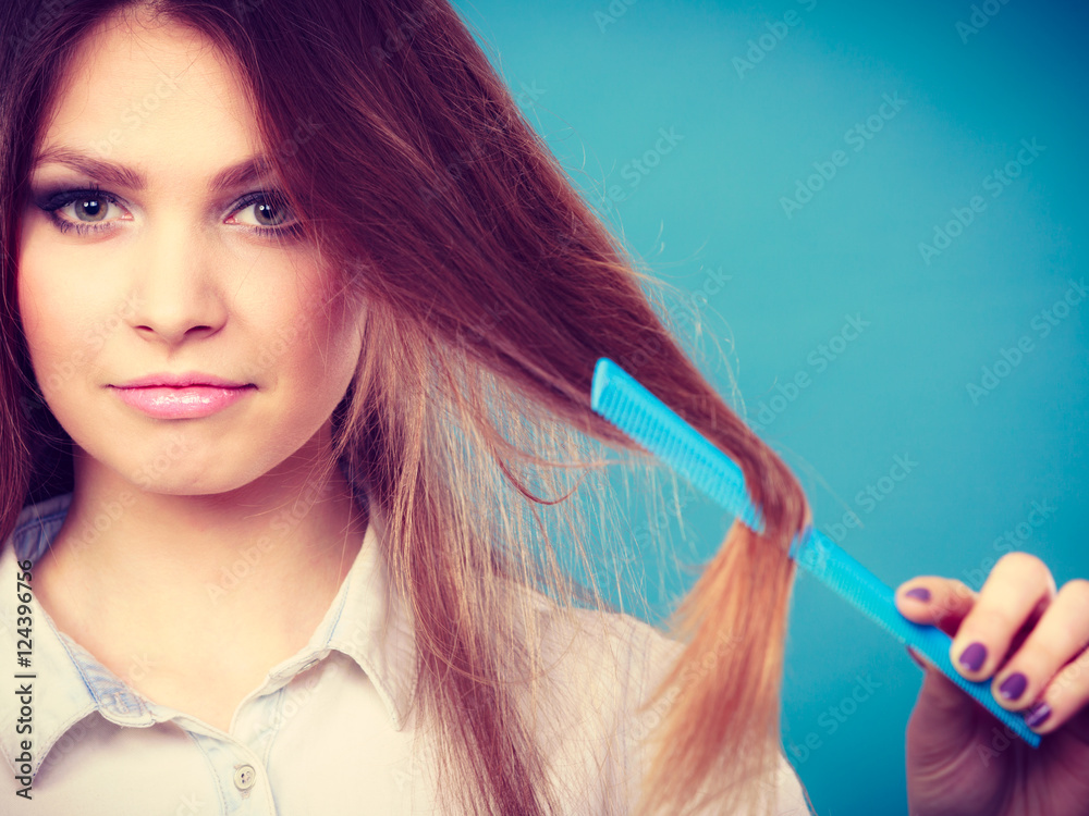 Long haired woman combing her hair.