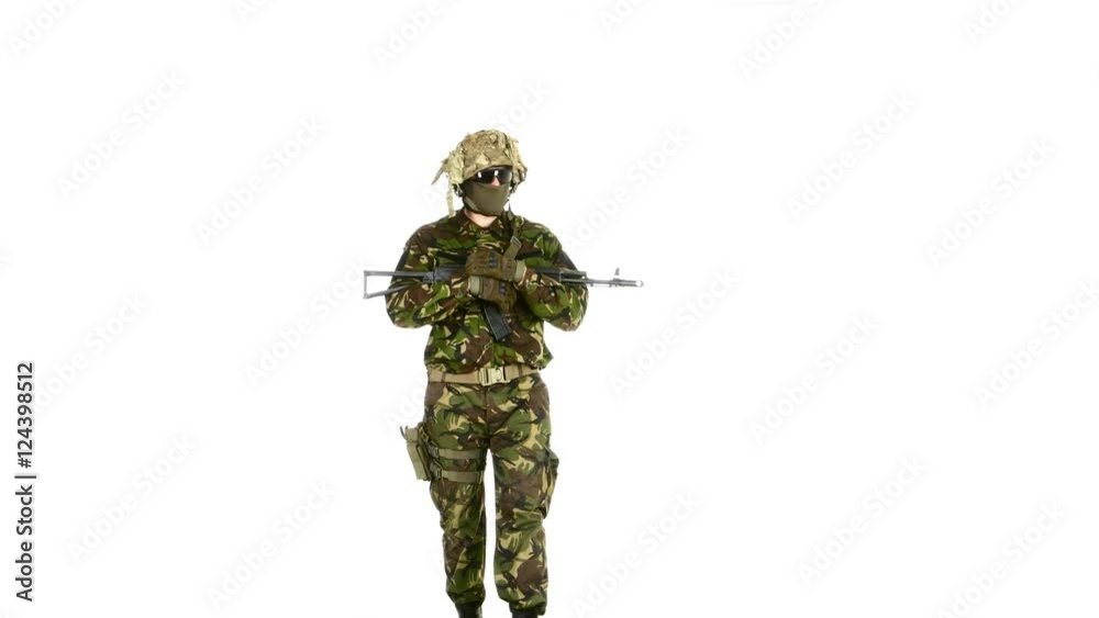 Soldier goes and holds the weapon in his hands. White backgraund Soldier goes and holds the weapon in his hands. White backgraund