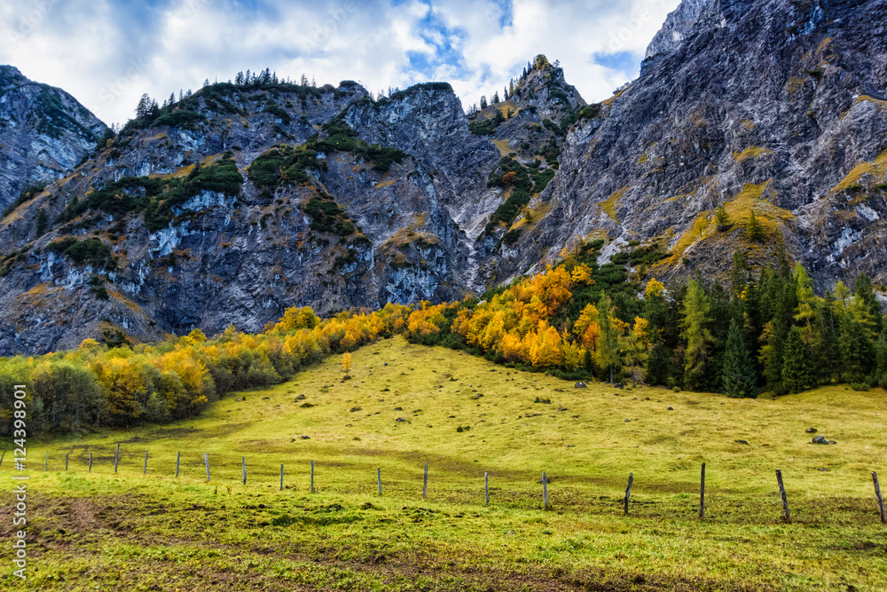 Obraz premium Alps autumn colorful mountain landscape with blue cloudy sky. Austria, Tyrol.