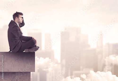 Peaceful sales guy sitting on roof top