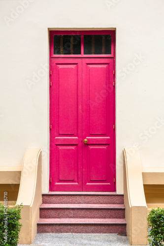 pink Door  on Cream Wall on pink staircase with small tree