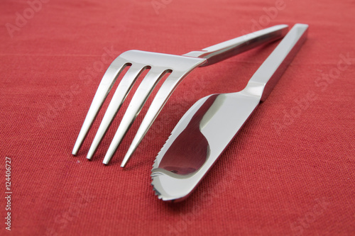 fork and knife  on red tablecloth