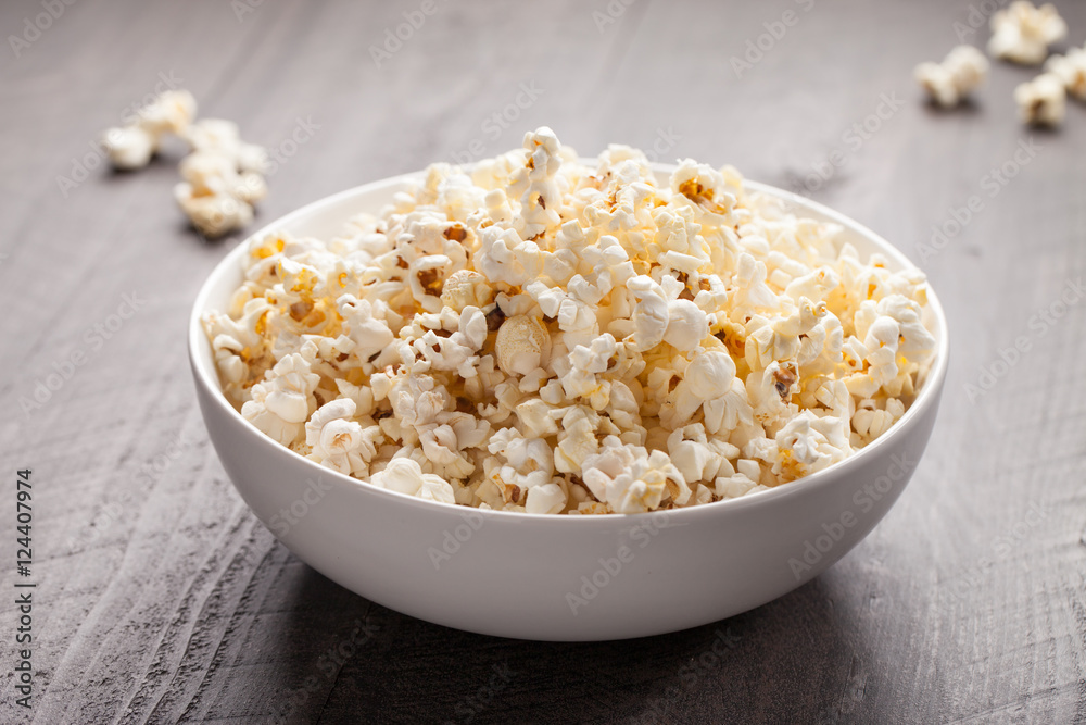 Olive oil popped popcorn in a porcelain bowl horizontal shot Olive oil popped popcorn in a porcelain bowl horizontal shot