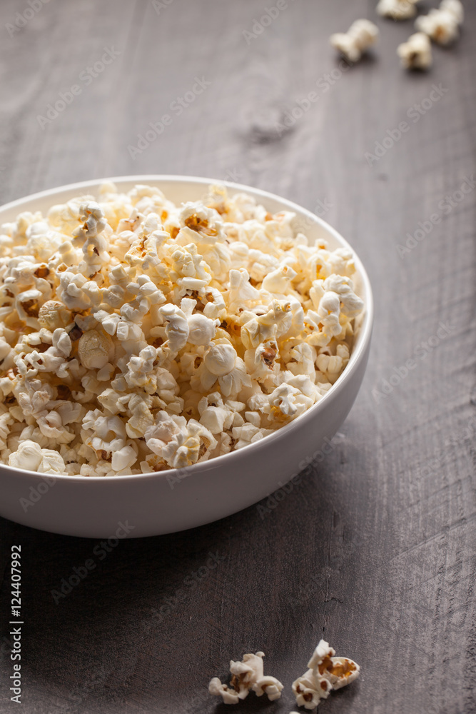 Olive oil popped popcorn in a porcelain bowl angled view Olive oil popped popcorn in a porcelain bowl angled view