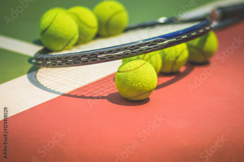 Tennis Ball with Racket on the clay tennis court © smolaw11