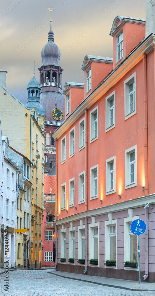 Narrow street with a view on the building of Dome church in old Riga that is the capital of Latvia and famous European city of medieval architecture