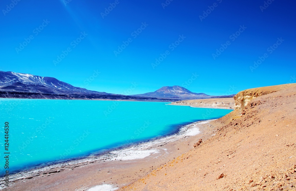 Long shot of the Laguna Verde with turquoise water, mountains in the background and a blue sunny sky in Chile, South America Long shot of the Laguna Verde with turquoise water, mountains in the background and a blue sunny sky in Chile, South America