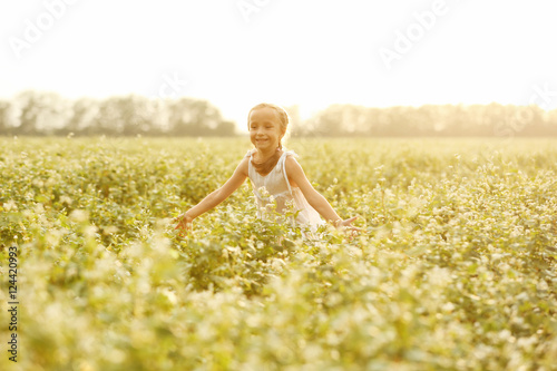 Happy little girl in the field