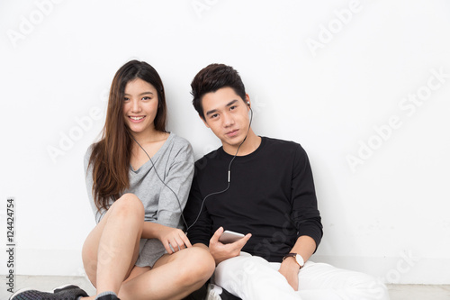 Asian couple listen to music