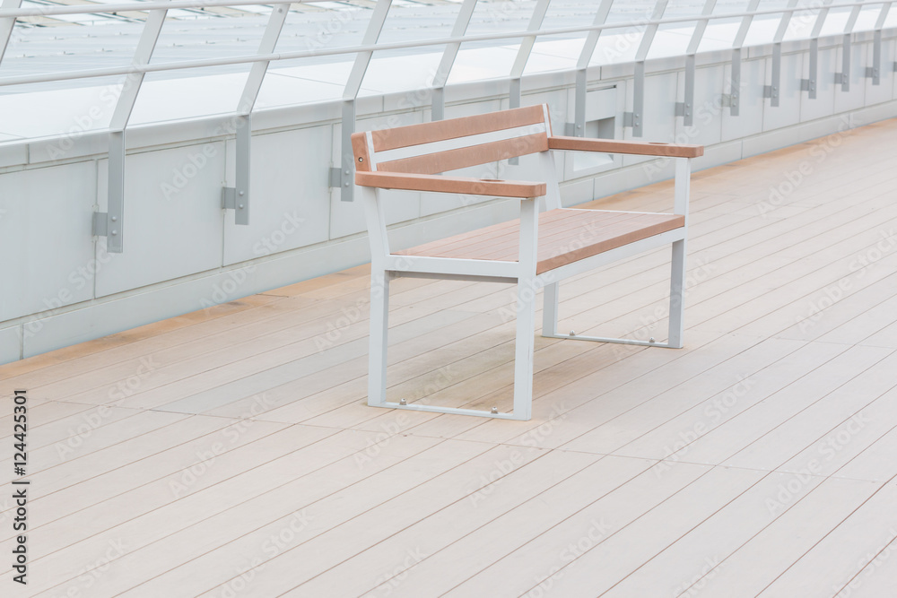 Empty wooden bench in park outdoor.