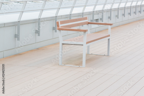 Empty wooden bench in park outdoor.