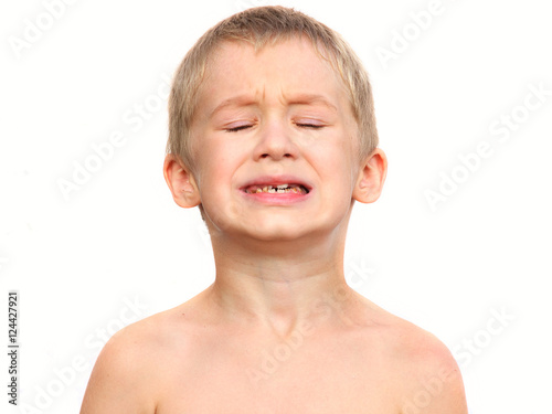 Little Boy Child making sore crying Face showing Calf's Teeth Decay Dental problems concept  isolated on white background photo
