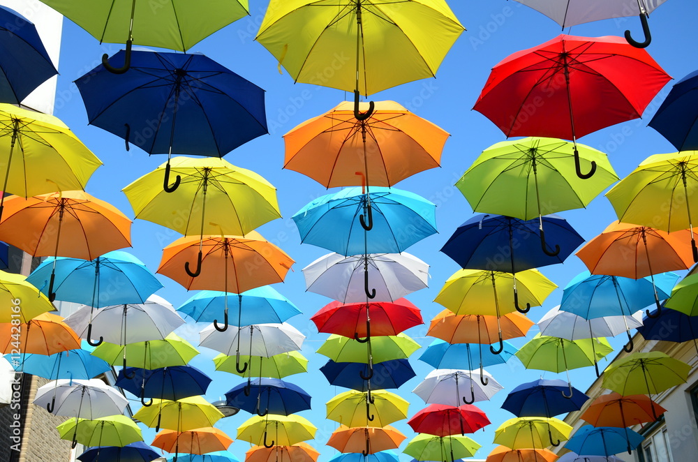 Colorful umbrellas background. Colorful umbrellas in the sunny sky. Street decoration.