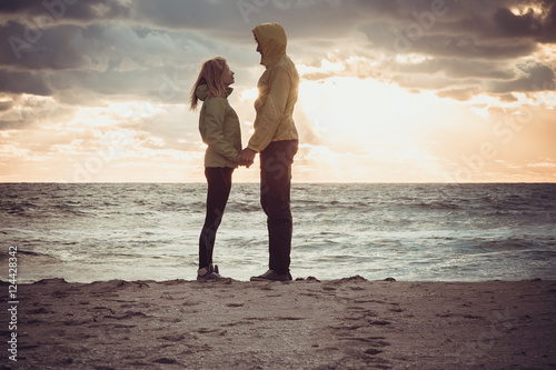 Wallpaper Mural Couple Man and Woman in Love standing on Beach seaside holding hand in hand with Beautiful Sunset sky scenery People Romantic relationship and Friendship concept trendy moody colors Torontodigital.ca