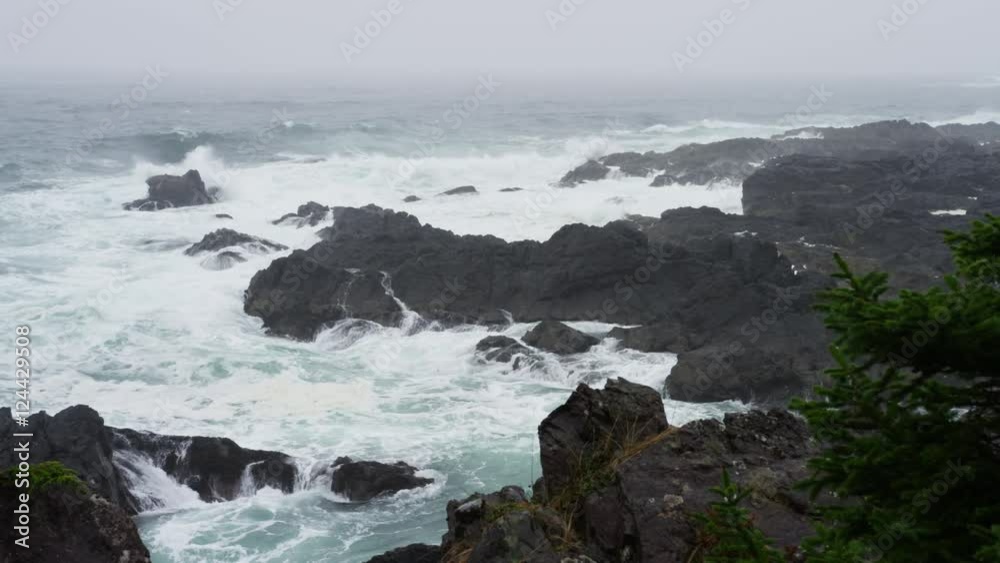 Rain gusts over a stormy ocean shoreline with waves crashing over black rocks. 4k. Rain gusts over a stormy ocean shoreline with waves crashing over black rocks. 4k.