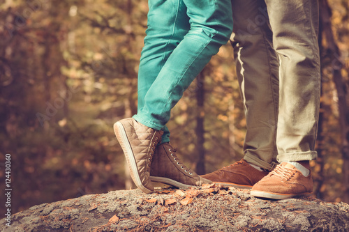 Couple Man and Woman Feet in Love Romantic  Outdoor Lifestyle with nature on background Fashion trendy style