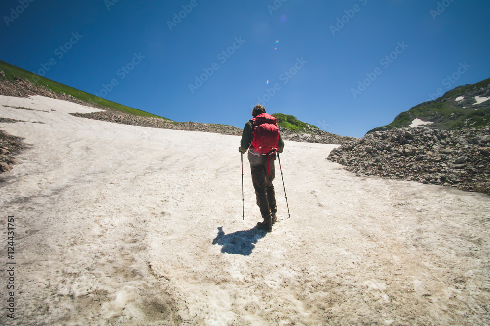 Young Man with backpack mountaineering glacier outdoor Travel Lifestyle concept mountains on background