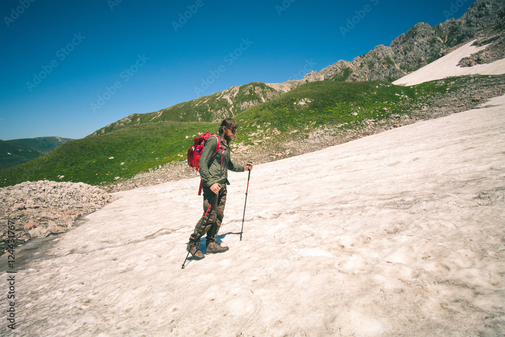 Traveler Man with backpack mountaineering glacier outdoor Travel Lifestyle concept mountains on background 