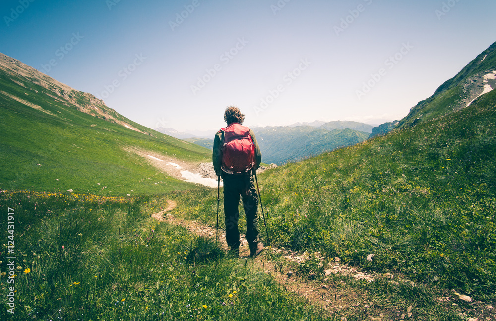 Man Traveler with backpack hiking outdoor Travel Lifestyle concept mountains on background Summer vacations