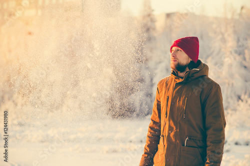 Young Man enjoying snow weather walking Outdoor Winter Lifestyle vacations nature on background